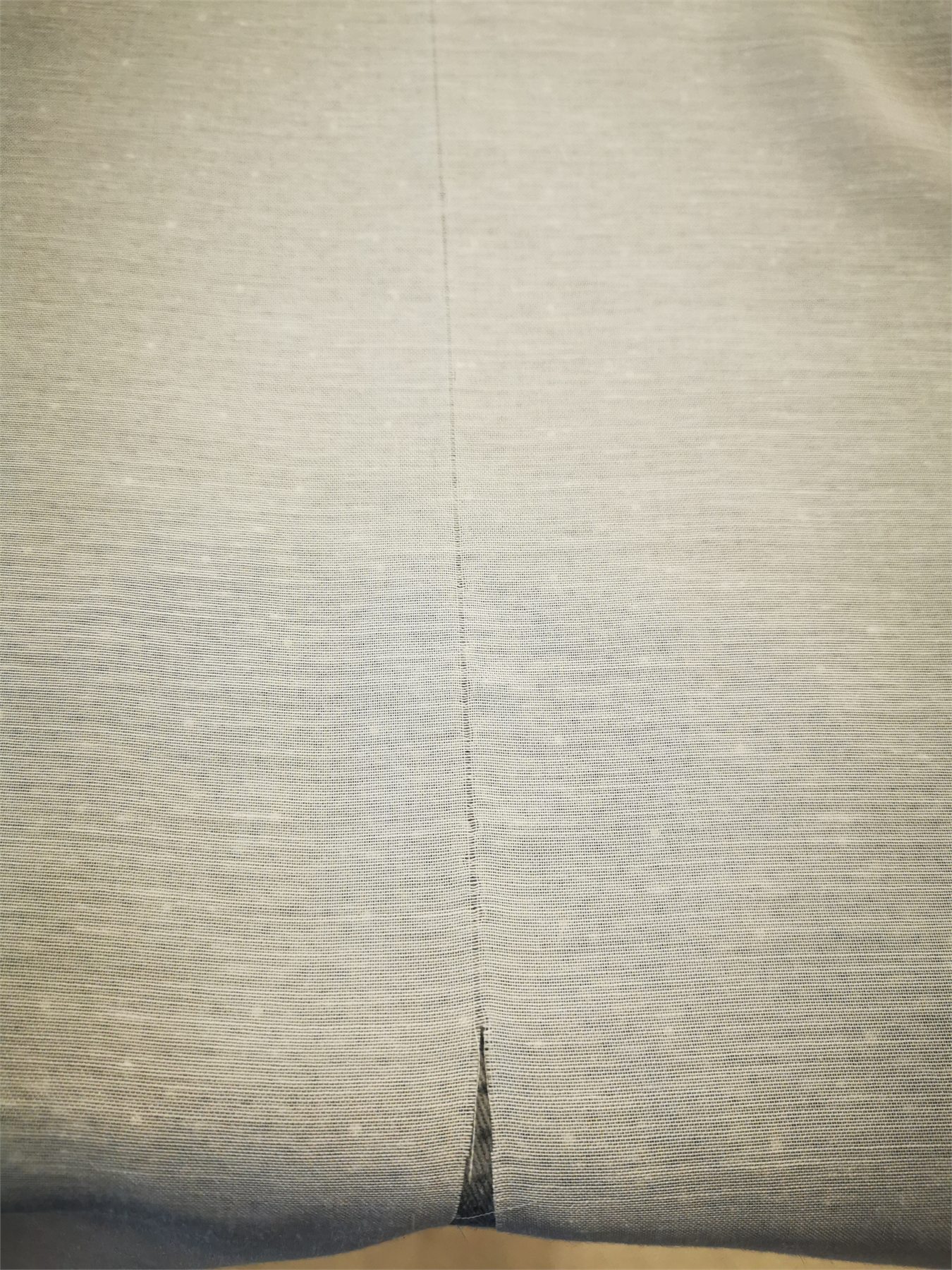 A vertical join sewn into the sheer curtain fabric.