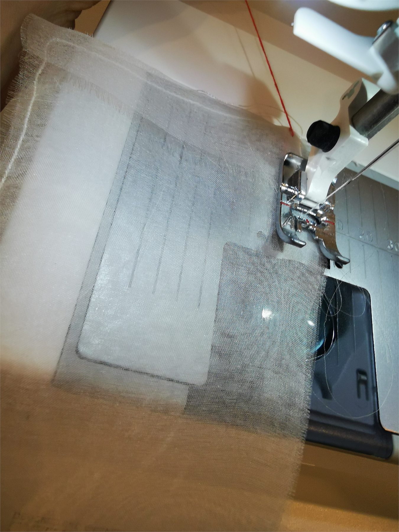 Two layers of organza being sewn for the curtain heading.