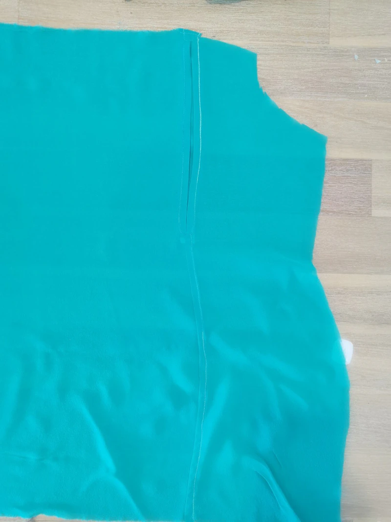 Completed lower pleat fastening and the topstitching continuing down the back seam.