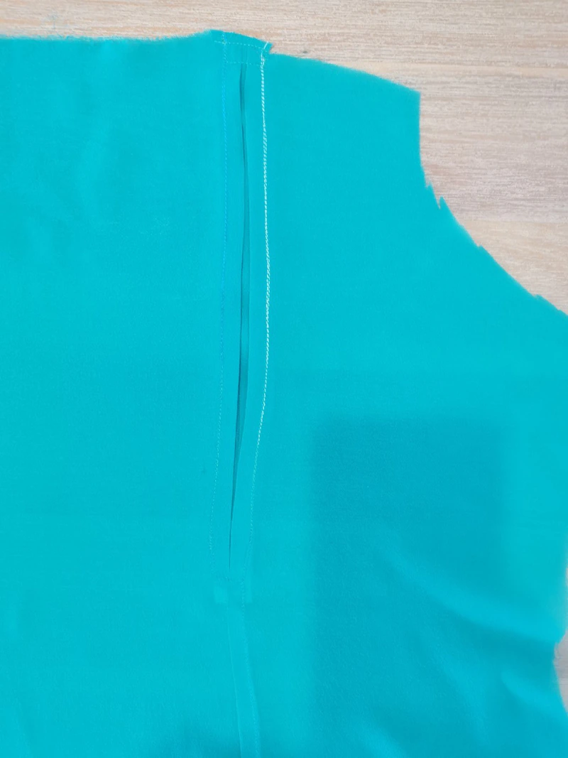 Top of the inverted pleat secured at the yoke edge.