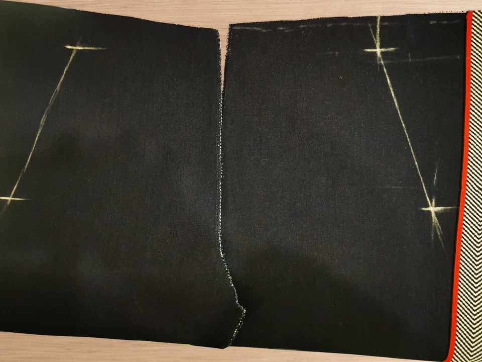Two navy trouser fronts with matching chalk pocket-opening marks.