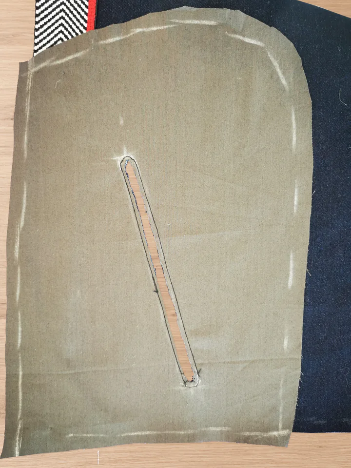 Narrow slot cut through the brown lining and navy front, with fabric allowance remaining inside the seam.