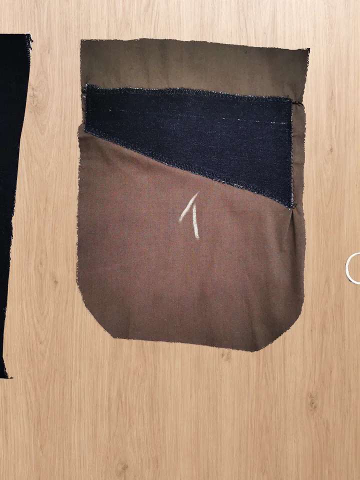 Navy main-fabric pocket facing zigzagged around its edges onto the brown pocket-bag backing.